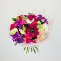 Joyful Blooms Bouquet - vibrant mix of hot pink, purple, peach and white flowers wrapped in white translucent paper