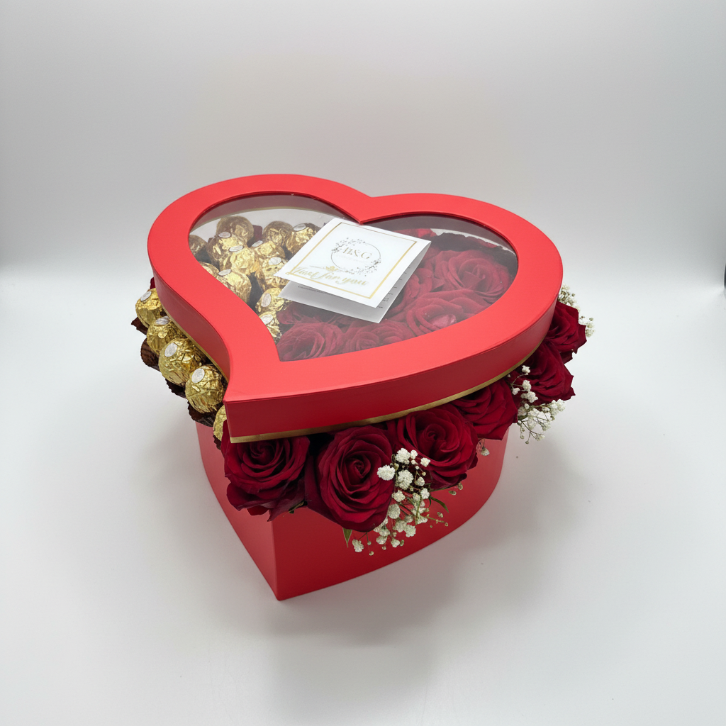 Heart shaped boxed bouquet with brand card, red roses and chocolates